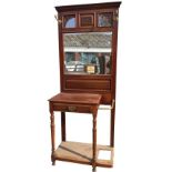 A late Victorian mahogany hallstand with moulded cornice above three leaf carved frames with