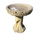 A composition stone birdbath, the dished log moulded bowl on treetrunk column support. (18in x 23.