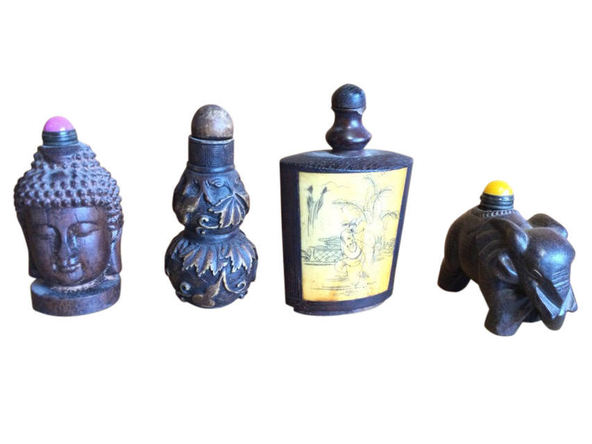 A carved wood snuff bottle with buddha head to sides; another carved hardwood bottle in the form