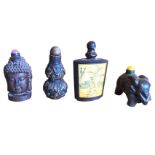 A carved wood snuff bottle with buddha head to sides; another carved hardwood bottle in the form