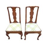 A pair of eighteenth century oak Queen Anne style side chairs, with shaped splats above drop-in