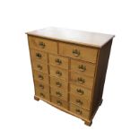 A craftsman made oak chest of 17 drawers, the rectangular moulded top above two drawers, with