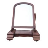 A Victorian mahogany dressing table mirror, the arched plate in moulded frame on scrolled