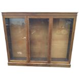 A C20th 6ft oak bookcase, with rectangular moulded top above a plain frieze and three glazed