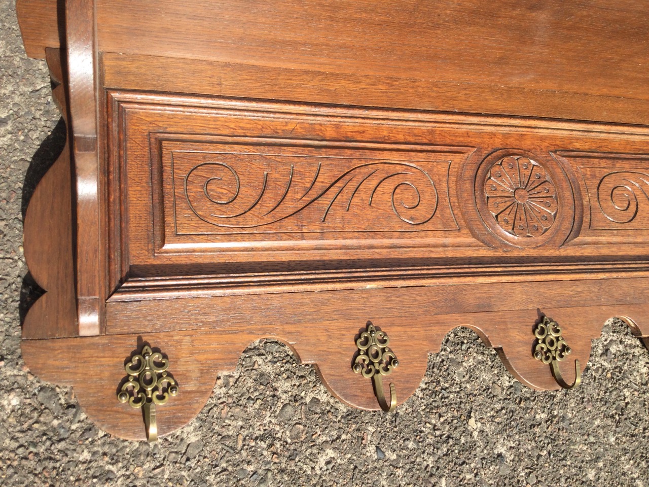 A late Victorian carved coat rack, having shelf on shaped supports above a scroll carved panel, with - Image 3 of 3