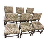 A set of six oak dining chairs with studded floral tapestry seats & backs, raised on bobbin turned