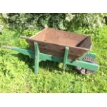 A large elm wheelbarrow with angled sides and tapering shafts, having pneumatic tyre. (60in)