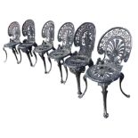 A married set of six metal garden chairs with spade shaped backs, having greek key pierced borders
