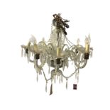 An Italian style glass chandelier with brass chain suspending a central bowl with etched glass