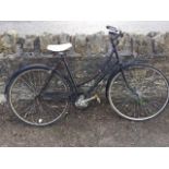 A vintage Raleigh ladies bicycle with mud guards, sprung seat, three gears, chain guard, etc.