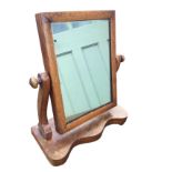 A Victorian mahogany dressing table mirror with rectangular cushion moulded plate on shaped