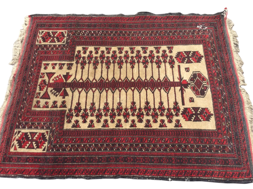 A Bokhara prayer rug woven with central serrated sword hung with pendants on fawn field, framed by