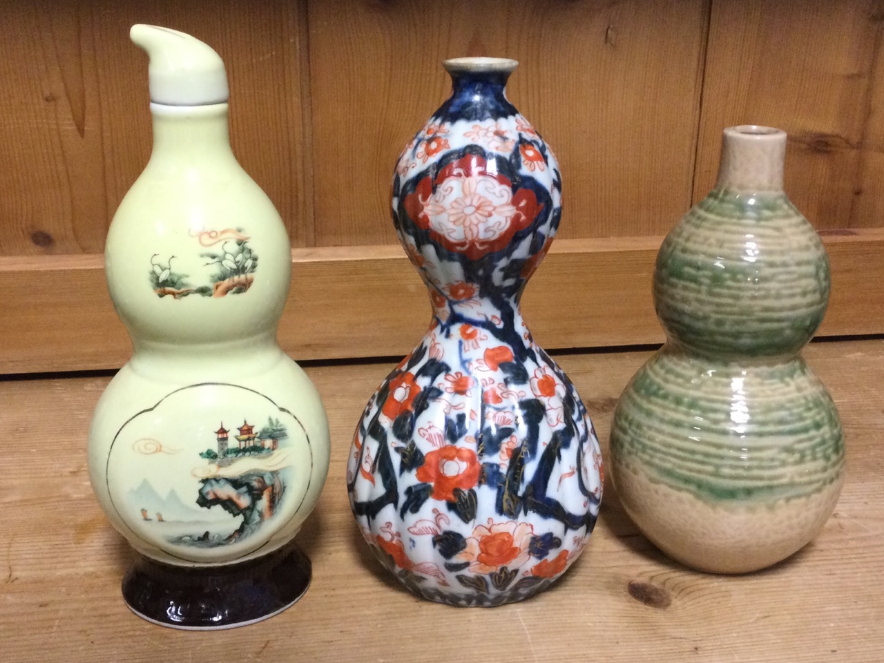 Three gourd shaped ceramic vases - ribbed and decorated in the Imari palette, mottled sancai type - Image 2 of 3