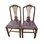 A pair of late Victorian oak side chairs, with arched back rails above pierced splats, having