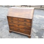 A George III oak bureau, the cleated fallfront enclosing a fitted interior with pigeonholes, drawers