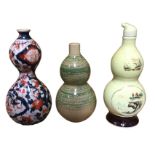Three gourd shaped ceramic vases - ribbed and decorated in the Imari palette, mottled sancai type