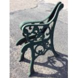 A pair of cast iron bench ends with scroll cast frames on channelled sabre legs - require re-