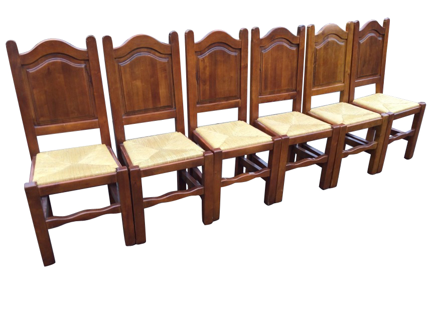 A set of six hardwood dining chairs with arched fielded panelled backs above drop-in rush seats,