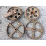 A pair of 15in cast iron wheels with flat rims, each with four spokes; and another pair of 13.5in