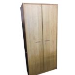 A large 7ft plain birch wardrobe with two doors enclosing hanging space and shelving. (39.75in x