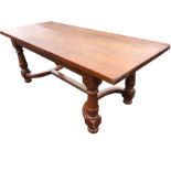 A continental style refrectory table with thick rectangular top on bulbous turned tapering legs