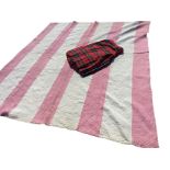 A pink & white striped cotton handsewn quilt; and a kilt in tartan by Hector Russell with leather