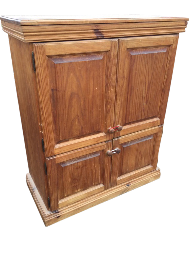 A pine cupboard with moulded cornice above four fielded panelled knobbed doors enclosing shelves,