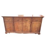 A mahogany sideboard, the rectangular top with dentil moulding above four cut-corner panelled