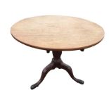 A Georgian snap-top mahogany table with circular top on turned column with spiral carving, raised on