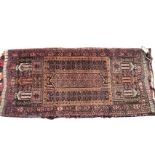 A Bokhara cushion cover woven in the form of a prayer mat, the central panel with three columns