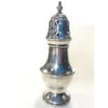 A hallmarked silver caster of baluster form with pierced cover and turned finial - Birmingham, 1936,