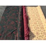Two rolls of floral upholstery material; and a roll of maroon coloured hessian style fabric. (3)