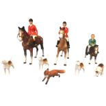 Four Beswick hounds and a Beswick fox; and a Beswick style mounted huntsman and huntswoman with