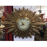 A Smiths Sectric sunburst wallclock, the dial with silvered chapter ring under convex glass, with