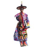 An exotic looking eastern gentleman, the manekin on chromed stand wearing colourful embroidered