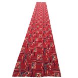 A long contemporary Axminster style runner woven in an abstract scrolled and wriggled design on