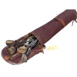 A set of Edwardian golf clubs in leather bag, with five wood headed drivers and eight irons - mainly