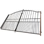A pair of arched driveway gates with grill poles having fleur-de-lils finials in rectangular frames,