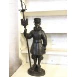A cast iron beefeater fireside figure holding a poker in the form of a sword in his staff, the
