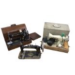 A late Victorian New Home cast iron sewing machine decorated with oval polychrome family panel &
