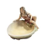 A Royal Dux porcelain figure of a girl at a shell moulded pool, decorated in the traditional