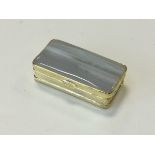 A rectangular agate pill box with hinged lid and moulded gilt metal sides – unmarked. (2.5in)
