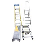 Two pairs of aluminium folding step ladders; a wrapped three-section loft ladder; and a telescopic