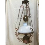 A rise & fall brass & copper oil lamp, with weighted mechanism on three chains suspended from