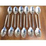A set of twelve coffee spoons modelled with twin golf club handles and ball finials - Walker & Hall,