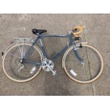 A handbuilt Dawes bicycle with drop handlebars, dynamo powered lights, Shimano gears, panier rack,