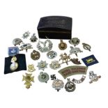 A collection of military cap badges - Essex Regiment, West Riding, Cheshire, some cloth badges,