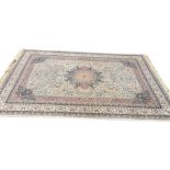 An oriental Borsah carpet woven with busy floral field on ivory ground framing a central