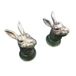 A pair of silver plated hare cruets inlaid with glass eyes, the salt & pepperpot heads on circular