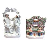 A Victorian Staffordshire flatback watch-holder of architectural form with two figures framing